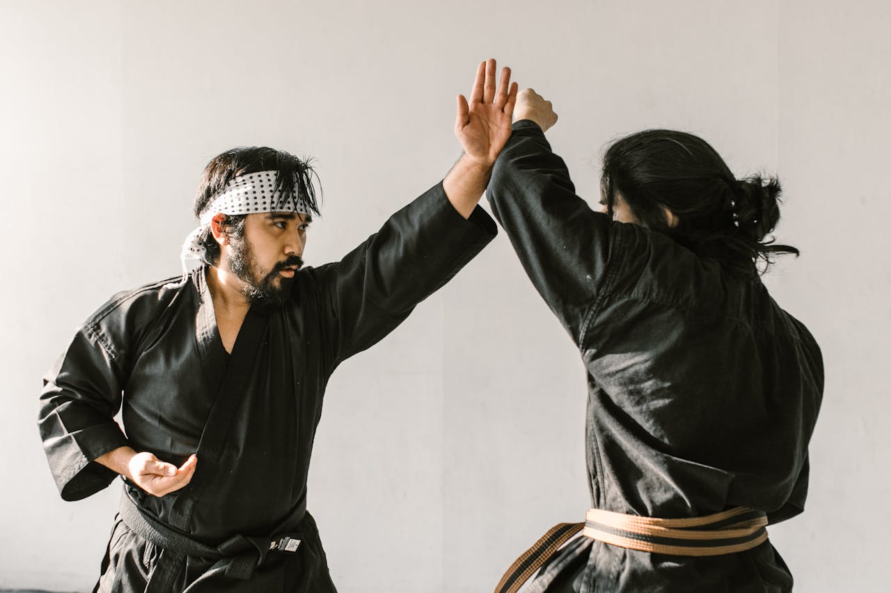 Mastering the First Impression: Your intriguing post title goes here Two martial artists practicing self-defense techniques indoors in a focused session.