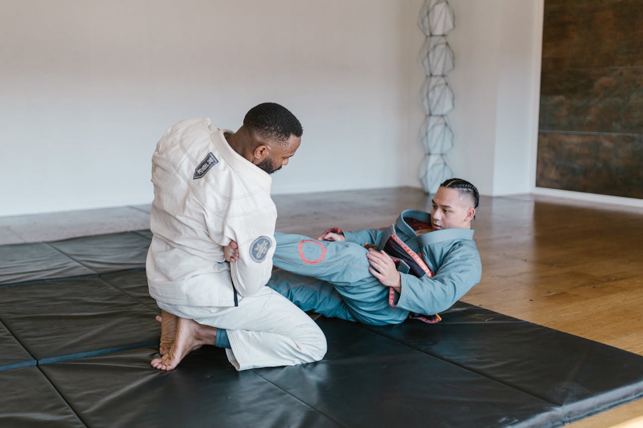 The Art of Drawing Readers In: Your attractive post title goes here Two men engaged in Brazilian Jiu-Jitsu practice on a mat in an indoor training room.